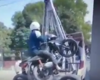 Motorcycle Towed With Owner Still Sitting on it